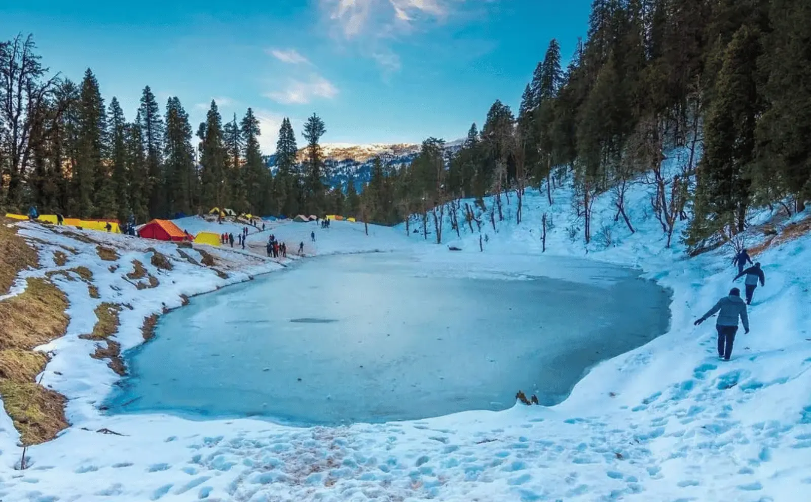 Frozen Juda Ka Talab during winter trek to Kedarkantha in Uttarakhand.