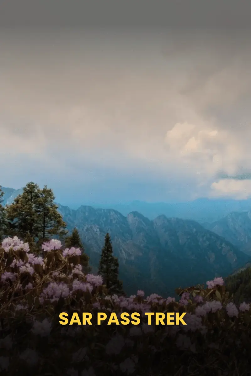 Trekking through Sar Pass with stunning views of snow-covered Himalayan peaks.